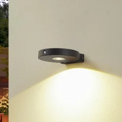 Lucande LED wandlamp Tavon, rond, zwart, sensor