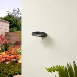 Lucande LED wandlamp Tavon, rond, zwart, sensor